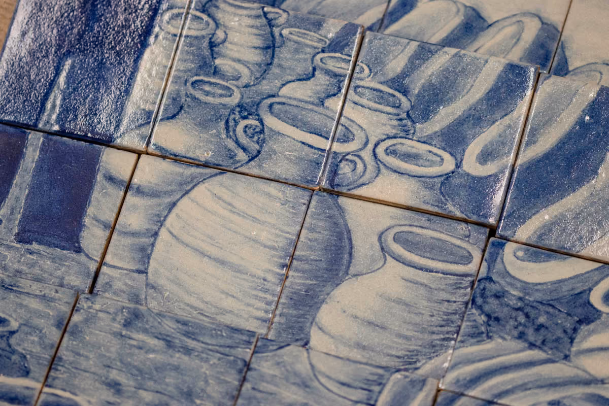 Close-up of glazed Talavera tiles painted with clay pots